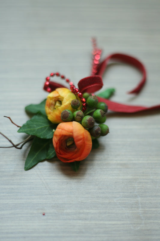 Citrus with green berries & red beads wrist corsage